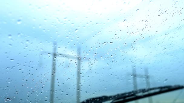 Windshield with raindrops wiped by automobile wipers.Rainy, stormy weather — Stock Video