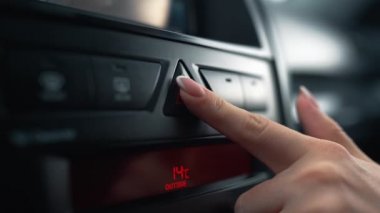 Tanınmayan kadının parmağı alarm düğmesine basıyor - arabada acil durum sinyali.
