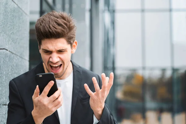 Businessman screaming on mobile phone. Having nervous breakdown at work, screaming in anger, stress management, mental distress problems, losing temper, reaction on failure