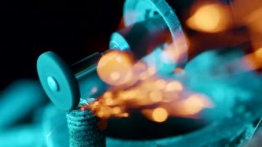 İnşaat fabrikasındaki öğütücüyle metal öğüten işçilere yakın çekim. Sanayi üretimi, çilingir endüstrisi konsepti. Parçalayan tekerlekten kıvılcımlar. 