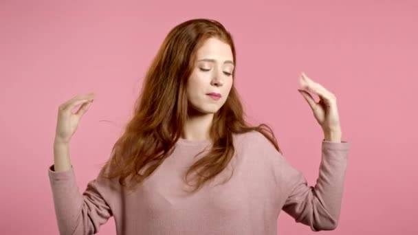 Cute girl showing bla-bla-bla gesture with hands and rolling eyes isolated on pink background. Empty promises, blah concept. Lier. — Stock Video