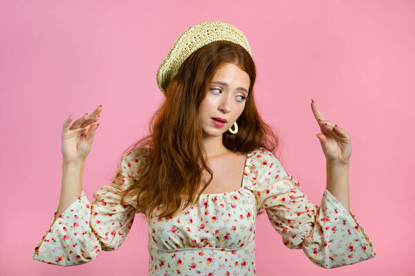 Cute girl showing bla-bla-bla gesture with hands and rolling eyes isolated on pink background. Empty promises, blah concept. Lier.