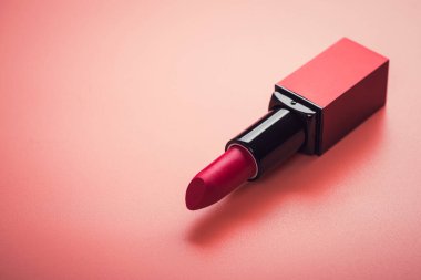 makyaj malzemesi kırmızı ruj pembe arka planda