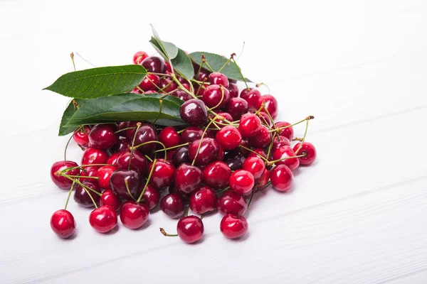 fresh red cherry on white wooden background