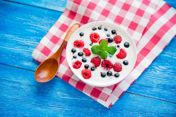 sweet breakfast with healthy food with fruit and yogurt on blue wood table