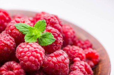 Tahta masadaki kasede taze kırmızı ahududu.