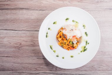 Sebzeli makarna ve beyaz tabakta parmesan peyniri. en üstteki görünüm