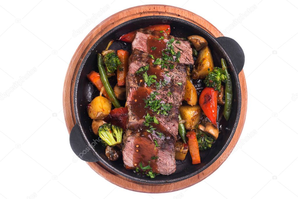 Hot metal pan with roast beef and vegetables isolated on a white background. top view
