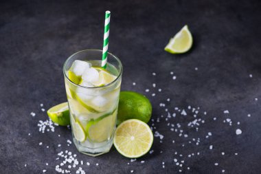 Taze yaz alkollü caipirinha 'sı taş bir masada. parti içeceği kokteyl arka planı