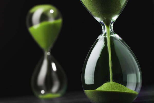 Sandglass, hourglass with sand. Time is running out. Speed of decision making in business.