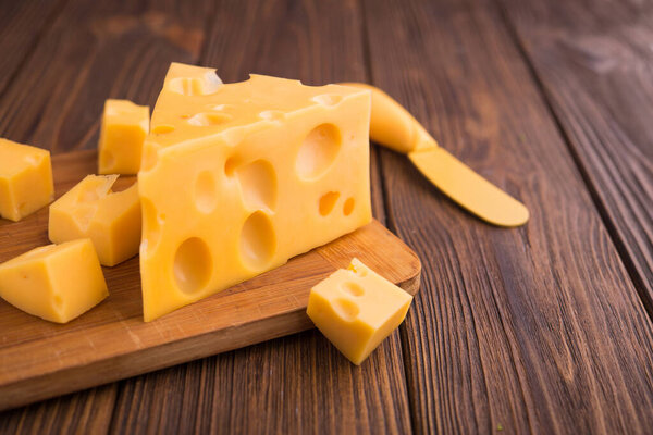 piece of cheese on a cutting board