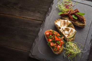 Aperatif İtalyan bruschetta ile kepekli domates ve peynirli peynir. en üstteki görünüm