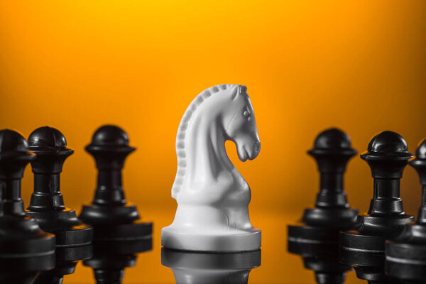 Emphasis on the knight chess piece, yellow background.