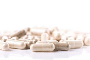 Sağlık bitkisel kapsülü beyaz arka planda izole edilmiş.