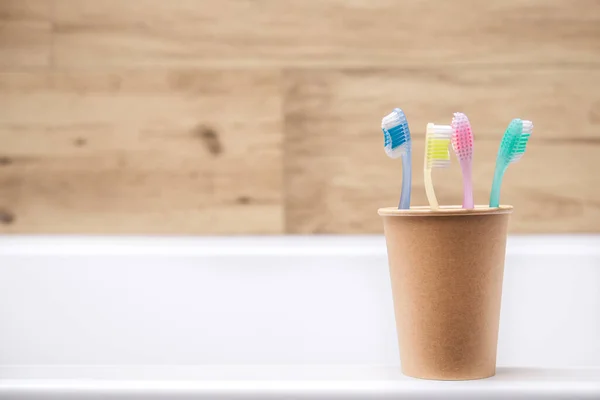 Four Toothbrushes Paper Cup Bathroom Hygiene Teeth Cleaning — Stock Photo, Image