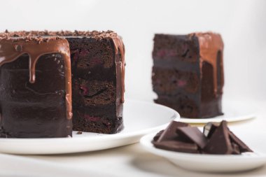 Beyaz masa örtüsü üzerinde çikolatalı pasta. Lezzetli kalori yemeği..