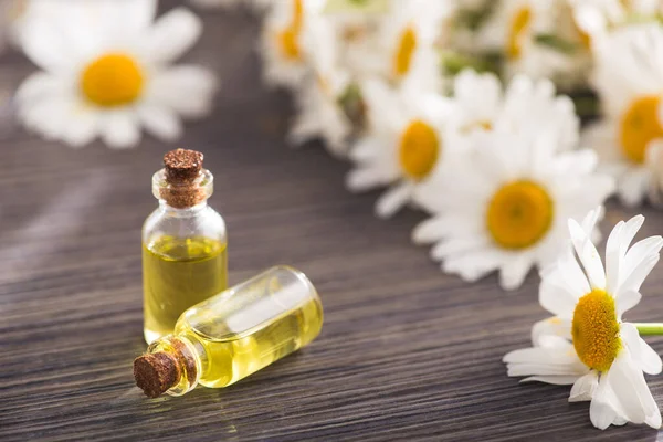 Glass Bottle Essential Aroma Chamomile Oil Flowers Wooden Table Concept — Stock Photo, Image