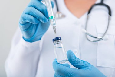 Klinikte elinde grip aşısı tutan kadın doktor. Hastanede doz aşısı..