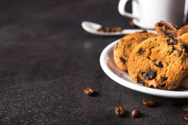 Koyu taşlı arka planda çikolata parçacıklı kurabiyeler