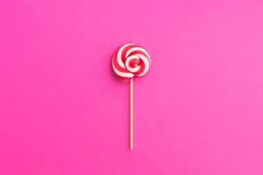 Pembe arka planda beyaz kırmızı lolipop. Pop Art. Üst Manzara. Parlak yaz tatlıları. En az besin.
