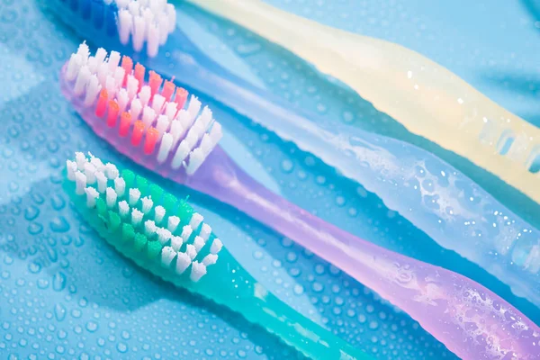 Colored Toothbrushs Water Drops Bathroom Blue Background — Stock Photo, Image