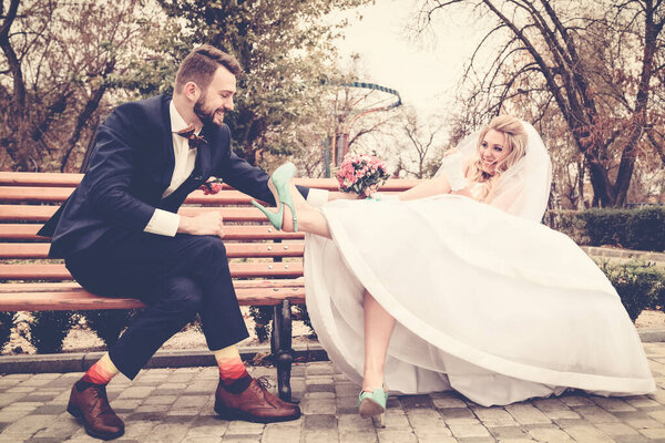 Bride and groom in bright clothes on the bench