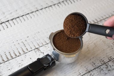 Bir sabah espresso yapmak için bir kahve makinesi Grup Başkanı içine öğütülmüş kahve dökülen kadın. Kahvaltı ve ev ekipman kavramı