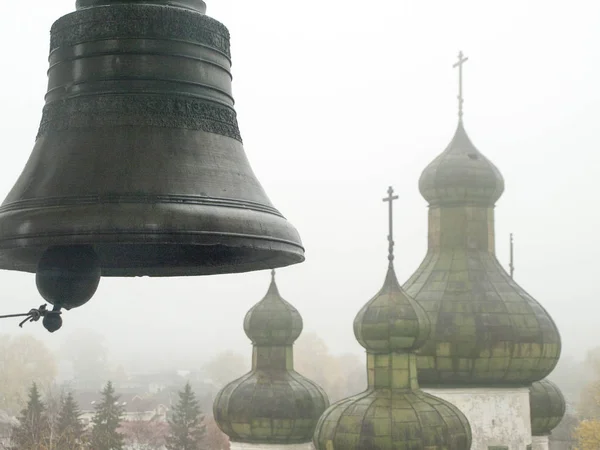 ell and domes of the church on the background of foggy Kargopol