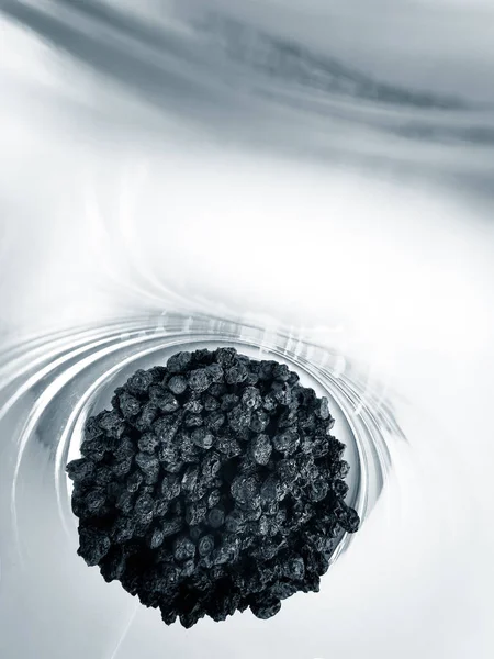 Dry blueberries in a glass beaker on a white — Stock Photo, Image