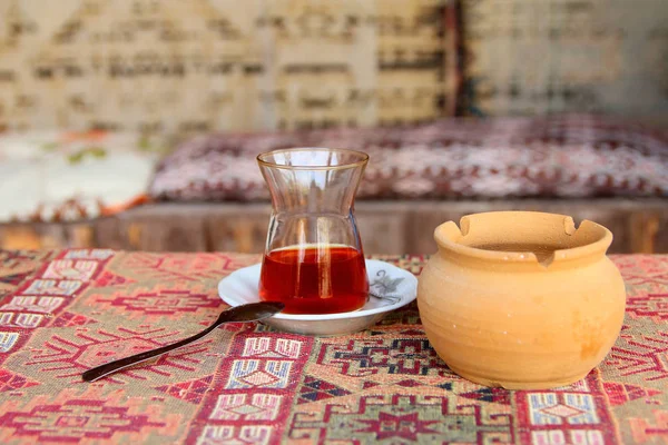 A glass of strong tea called - Armud on a traditional Turkish ru