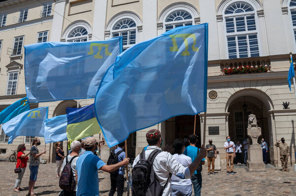 Lviv, Ukraine - June 26, 2020: Day of the Crimean Tatar flag. Raising the national flag in front of the city hall.