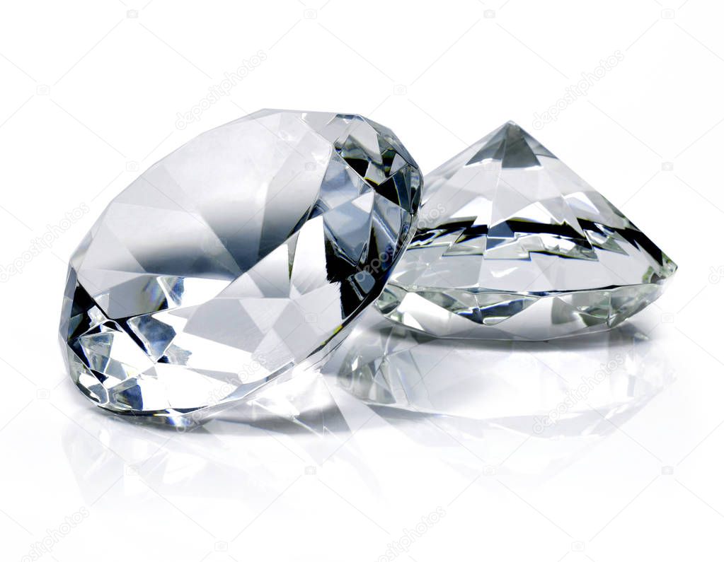 Beautiful shiny diamonds, isolated on white background. Clear or transparent diamonds, close-up shot.