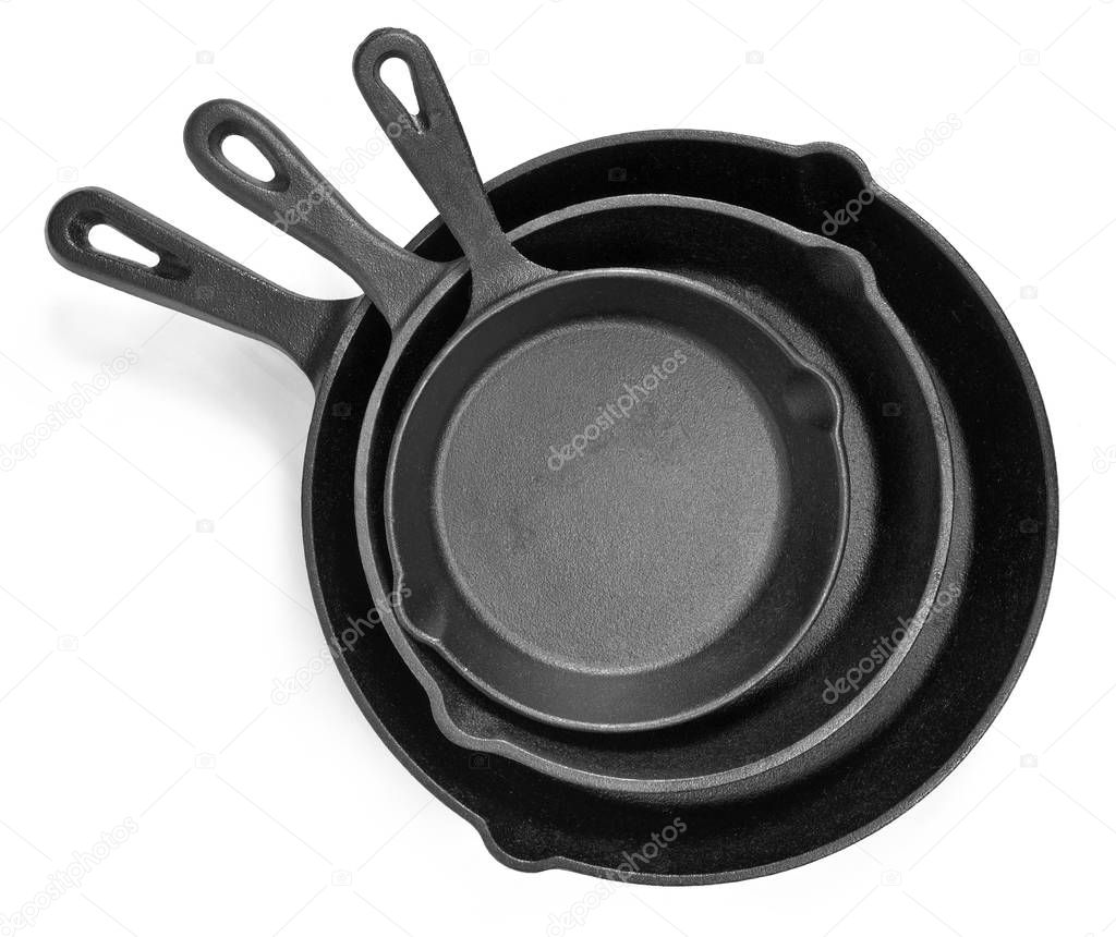 Cast iron pans with empty space, isolated on white background. Cut out objects with top view or high angle view and copy space.