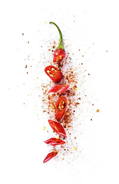 Red chili pepper, cut into pieces and isolated on white background. Hot spice, red chili pepper and chili powder.