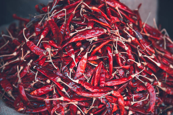 Closeup photo of a big pile of a red chili peppers, spicy seasoning, hot spice, traditional nutrition of Sri Lank