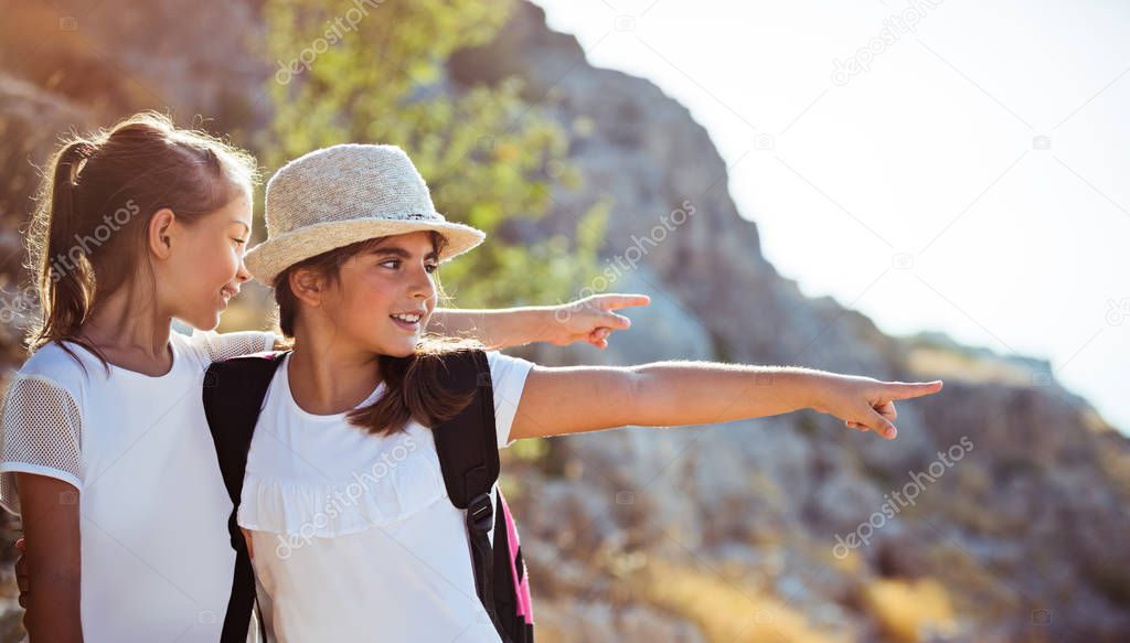 Two girls enjoying walking tour to mountains