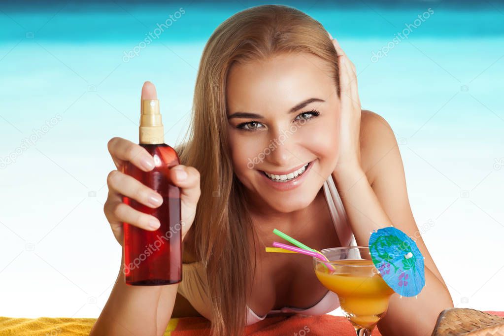 Happy woman tanning on the beach