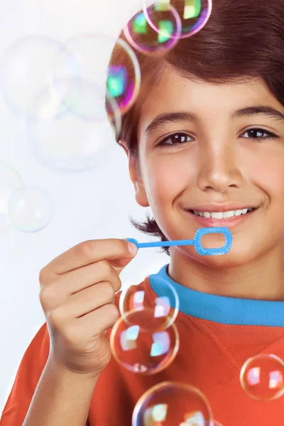 Happy boy blowing bubbles — Stock Photo, Image