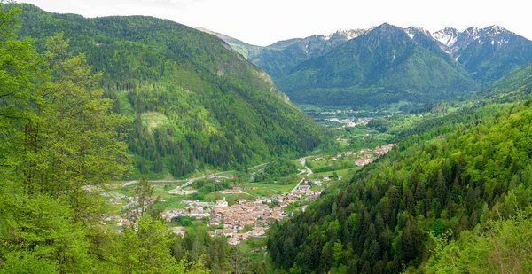 View with a mountain village surrounded by mountains - in a summer day