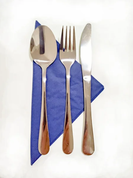 Blue bowl with tableware - spoon, fork and knife - table / dinner / breakfast / lunch arrangement