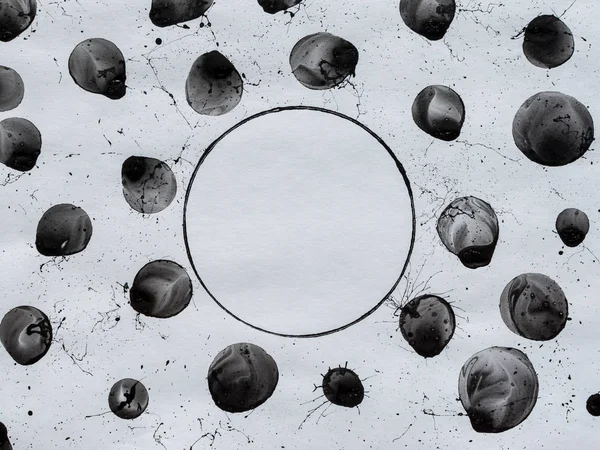 Black bubbles, circles and splashes. Black and white background. BW. Spray