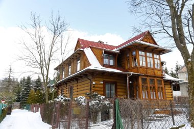 Zakopane, Polonya - 21 Mart 2018: Geleneksel ahşap evin geri 1929 civarında tarih ve yerel olarak bizim Villa bilinir. Bu evin mülkiyet çitin arkasında görülür