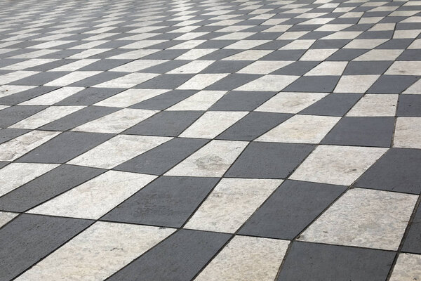 A mosaic pavement built of white and black stone slabs that cover Massena Square in Nice, France.