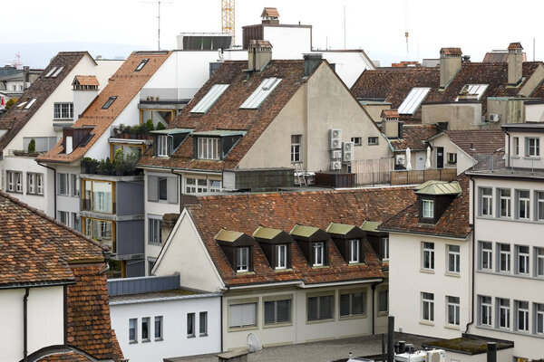 Bern Switzerland - September 14, 2018: View towards tenement houses and their roofs. It is a downtown district of medieval capital city.