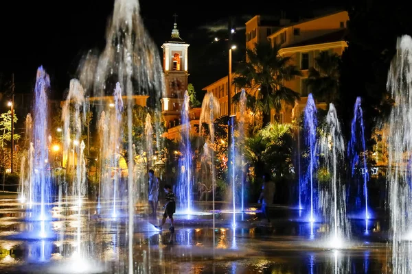 Blue lights and jets of water — Stock Photo, Image