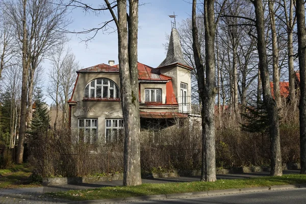 Bakstenen huis omgeven door planten en bomen — Stockfoto