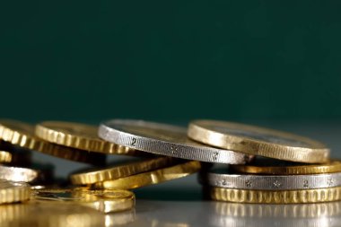 Birkaç avro sikke ayarlandı. Bu durumda, gri ve koyu yeşil bir arka plana yerleştirilirler..