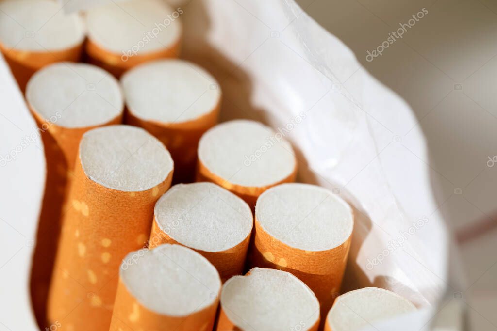 A pack of cigarettes is open and there are several cigarettes in an already incomplete pack. These are filter cigarettes.