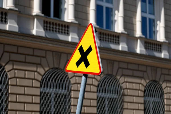 Road sign, corresponding intersection, indicates that vehicles on the right have the right of way according to the road rules here in Warsaw, Poland.