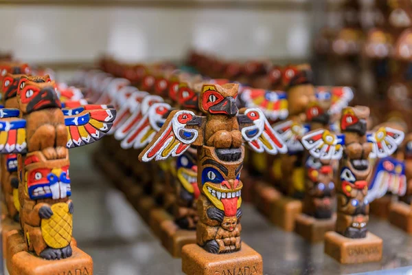Carved wooden First Nations Native American Indian totem pole souvenirs at a tourist shop in Vancouver Canada